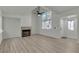 Bright living room with a fireplace, large windows, and light-colored flooring at 2461 Old Forge Ln # 103, Las Vegas, NV 89121