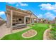 Backyard featuring a covered patio with seating, putting green, and well-maintained landscaping at 2654 Summit Springs St, Henderson, NV 89044