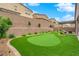 View of backyard putting green with mature landscaping and privacy walls at 2654 Summit Springs St, Henderson, NV 89044