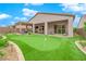 Beautiful backyard with a putting green, covered patio, and outdoor seating area perfect for entertaining at 2654 Summit Springs St, Henderson, NV 89044