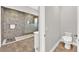 Modern bathroom with gray tiled walk-in shower and tiled floors at 2654 Summit Springs St, Henderson, NV 89044