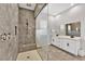 Modern bathroom featuring a glass shower with decorative wave design, double vanity, and tile flooring at 2654 Summit Springs St, Henderson, NV 89044