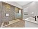 Bathroom featuring a glass-enclosed shower, double sinks, and neutral tile at 2654 Summit Springs St, Henderson, NV 89044