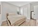 Bright bedroom with light wood flooring, a comfortable bed, and a closet with sliding doors at 2654 Summit Springs St, Henderson, NV 89044