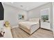 Neutral bedroom with a window, TV, and light-colored walls and flooring at 2654 Summit Springs St, Henderson, NV 89044