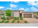 Charming exterior showcasing an attached garage, complemented by lush front yard landscaping at 2654 Summit Springs St, Henderson, NV 89044