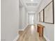 Bright hallway with light wood floors and modern decorative wall art at 2654 Summit Springs St, Henderson, NV 89044