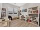 Bright home office with two windows, light wood floors, a built-in bookshelf and work space at 2654 Summit Springs St, Henderson, NV 89044