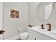 Stylish powder room featuring a round mirror, modern fixtures, and decorative wall art at 2654 Summit Springs St, Henderson, NV 89044