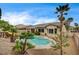 Expansive backyard with sparkling pool and mature palms offering a private oasis for relaxation and recreation at 2939 Crown Bluffs Ct, Las Vegas, NV 89117
