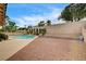The backyard boasts a pool with a slide, palm trees, and desert landscaping at 2939 Crown Bluffs Ct, Las Vegas, NV 89117