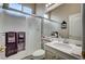 Bathroom with glass shower doors, single vanity, and neutral color palette at 2939 Crown Bluffs Ct, Las Vegas, NV 89117