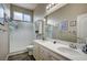 Bright bathroom featuring a dual sink vanity and frosted glass shower at 2939 Crown Bluffs Ct, Las Vegas, NV 89117
