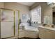 Bathroom featuring a garden tub, shower, and vanity with neutral tile at 2939 Crown Bluffs Ct, Las Vegas, NV 89117