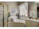 Bathroom featuring a garden tub, shower, and vanity with neutral tile at 2939 Crown Bluffs Ct, Las Vegas, NV 89117