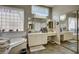 Elegant bathroom featuring a double vanity, soaking tub, walk-in shower, and vanity at 2939 Crown Bluffs Ct, Las Vegas, NV 89117