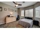 This bedroom features a ceiling fan and large windows at 2939 Crown Bluffs Ct, Las Vegas, NV 89117