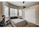 Bedroom featuring carpeted floors, a ceiling fan, large windows, and a closet at 2939 Crown Bluffs Ct, Las Vegas, NV 89117