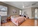 Bright bedroom boasts wood floors, and neutral walls and an ensuite bathroom at 2939 Crown Bluffs Ct, Las Vegas, NV 89117