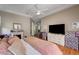 Bedroom features hardwood floors, a ceiling fan, and a fireplace at 2939 Crown Bluffs Ct, Las Vegas, NV 89117