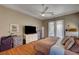 Spacious bedroom featuring tray ceilings, fan, closet, backyard access, and ample storage at 2939 Crown Bluffs Ct, Las Vegas, NV 89117