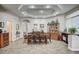 Elegant dining room features a tray ceiling, tile floors, and an abundance of natural light at 2939 Crown Bluffs Ct, Las Vegas, NV 89117
