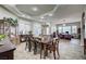 Dining room with large dark wood table and adjacent office area filled with natural light at 2939 Crown Bluffs Ct, Las Vegas, NV 89117