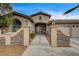 Charming stucco home featuring a gated entry, manicured landscaping, and a two-car garage at 2939 Crown Bluffs Ct, Las Vegas, NV 89117