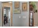 Hallway featuring floral artwork and an antique clock leading to the breakfast nook at 2939 Crown Bluffs Ct, Las Vegas, NV 89117