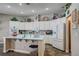 Open kitchen features white cabinets, a central island, and modern appliances at 2939 Crown Bluffs Ct, Las Vegas, NV 89117