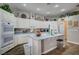 Bright kitchen with an island, white cabinetry, double ovens, and modern appliances at 2939 Crown Bluffs Ct, Las Vegas, NV 89117