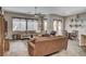 Open-concept living room featuring comfortable seating, a ceiling fan, and easy access to the breakfast nook at 2939 Crown Bluffs Ct, Las Vegas, NV 89117