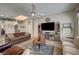 Inviting living room featuring a modern entertainment center and comfortable seating arrangement at 2939 Crown Bluffs Ct, Las Vegas, NV 89117