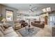 Spacious living room with plush seating, a ceiling fan, and plenty of natural light at 2939 Crown Bluffs Ct, Las Vegas, NV 89117