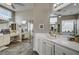 Main bathroom showcasing double sinks, mirrors, and a vanity area with tiled floors at 2939 Crown Bluffs Ct, Las Vegas, NV 89117