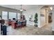 Spacious office area with tile floors, a ceiling fan, multiple windows, and an organized workspace at 2939 Crown Bluffs Ct, Las Vegas, NV 89117