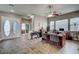 An office with a tiled floor, ceiling fan, windows, and an elegant double door entrance at 2939 Crown Bluffs Ct, Las Vegas, NV 89117