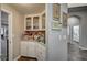 Charming pantry with white cabinets, glass doors, and countertop space for storage and organization at 2939 Crown Bluffs Ct, Las Vegas, NV 89117