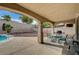 Covered patio area featuring dining table and chairs, and a view of the backyard pool and landscaping at 2939 Crown Bluffs Ct, Las Vegas, NV 89117