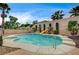 Backyard pool and slide with lush landscaping and a mature palm tree at 2939 Crown Bluffs Ct, Las Vegas, NV 89117