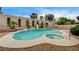 Backyard pool and spa combo feature clean design, rock feature and a slide at 2939 Crown Bluffs Ct, Las Vegas, NV 89117