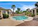Inviting pool area with a slide, lush landscaping, and clear blue water for refreshing swims at 2939 Crown Bluffs Ct, Las Vegas, NV 89117