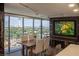 Bright dining room with city views, with wood table and seating for six at 3111 Bel Air Dr # 15G, Las Vegas, NV 89109