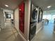 Hallway with artwork and a stackable washing machine and dryer at 3111 Bel Air Dr # 15G, Las Vegas, NV 89109