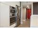 Stainless steel oven and refrigerator are situated along the hall to the rooms at 3111 Bel Air Dr # 15G, Las Vegas, NV 89109