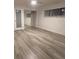 A bright bedroom with sleek gray flooring, closet with mirror doors, and a modern ceiling fan at 321 Beaumont St, Las Vegas, NV 89106