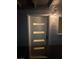 Contemporary front door illuminated by a stylish sconce, offering a warm welcome at 321 Beaumont St, Las Vegas, NV 89106