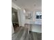 Bright kitchen area with island bar, all-white cabinets, and vinyl flooring at 321 Beaumont St, Las Vegas, NV 89106