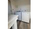 Bright laundry room featuring sleek, modern, white washer and dryer units and white countertop at 321 Beaumont St, Las Vegas, NV 89106