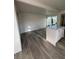 Well-lit living area featuring sleek flooring, kitchen island, and sliding doors at 321 Beaumont St, Las Vegas, NV 89106